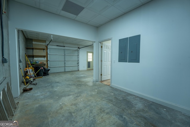 garage with electric panel and baseboards