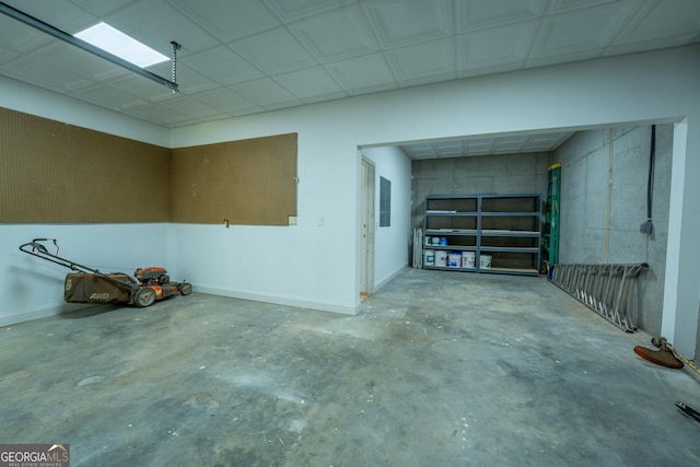 garage featuring electric panel and baseboards