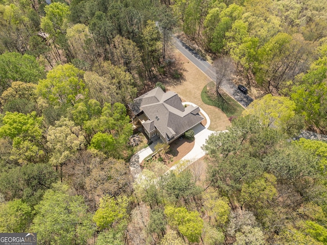 birds eye view of property with a forest view