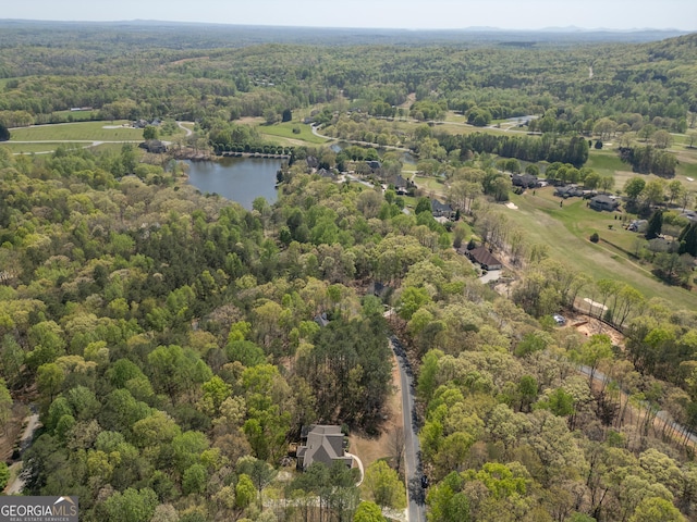 birds eye view of property featuring a view of trees and a water view