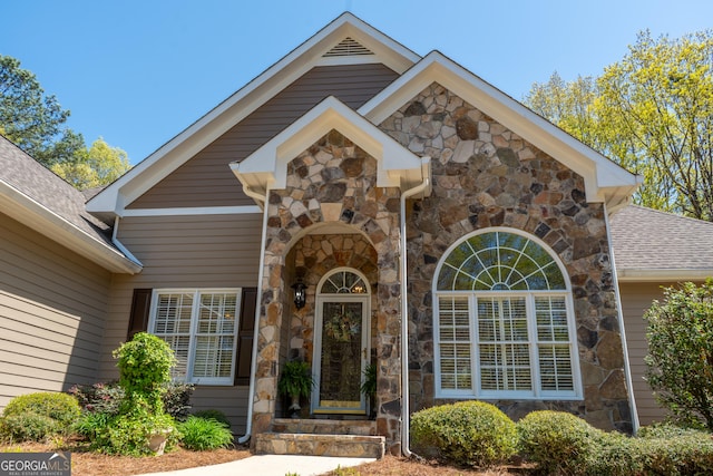 doorway to property with stone siding