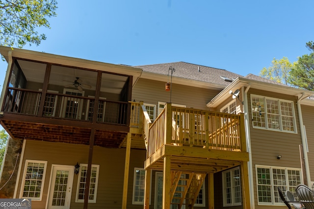 rear view of house featuring a deck and a shingled roof