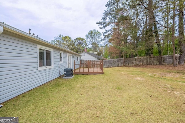 view of yard with central AC, a wooden deck, and fence private yard