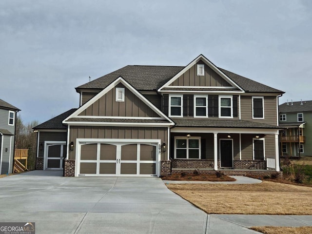 craftsman inspired home featuring board and batten siding, driveway, covered porch, brick siding, and a garage