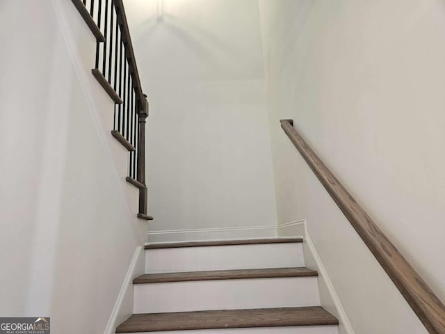 staircase featuring baseboards