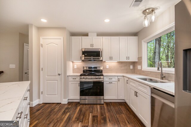 2183 Seaman Cir, Atlanta, GA 30341 - kitchen with white cabinets, visible vents, stainless steel appliances, dark wood finished floors, and a sink