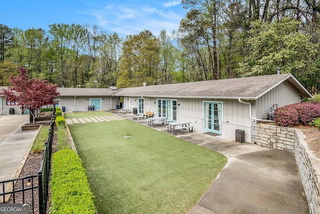 2183 Seaman Cir, Atlanta, GA 30341 - back of property with fence, french doors, board and batten siding, a yard, and a patio area