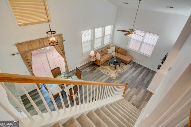 102 Manley Ct, Woodstock, GA 30188 - stairs with high vaulted ceiling, baseboards, wood finished floors, a chandelier, and ceiling fan