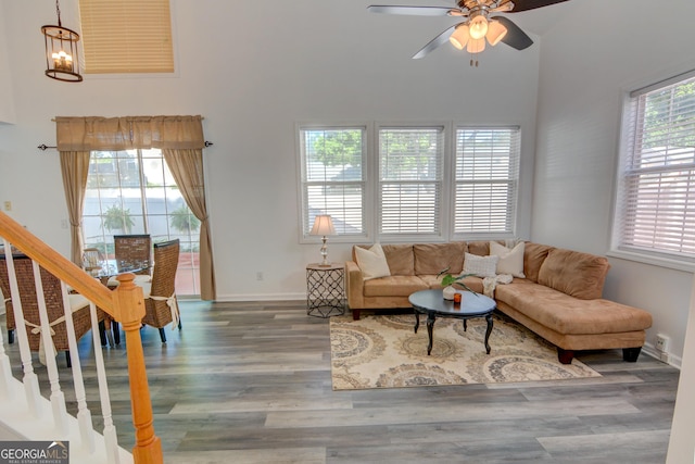 102 Manley Ct, Woodstock, GA 30188 - living area featuring a high ceiling, wood finished floors, a ceiling fan, stairs, and baseboards