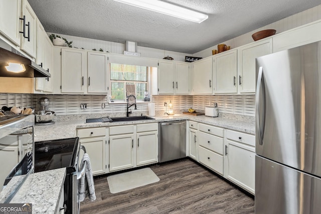 95 Joshua Ct, Zebulon, GA 30295 - kitchen featuring stainless steel appliances, a textured ceiling, dark wood-style floors, backsplash, and white cabinetry