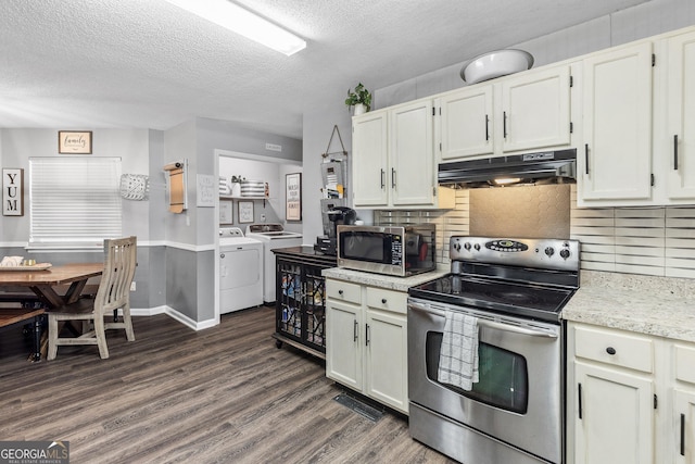 95 Joshua Ct, Zebulon, GA 30295 - kitchen featuring appliances with stainless steel finishes, washer and dryer, under cabinet range hood, dark wood-style flooring, and a textured ceiling