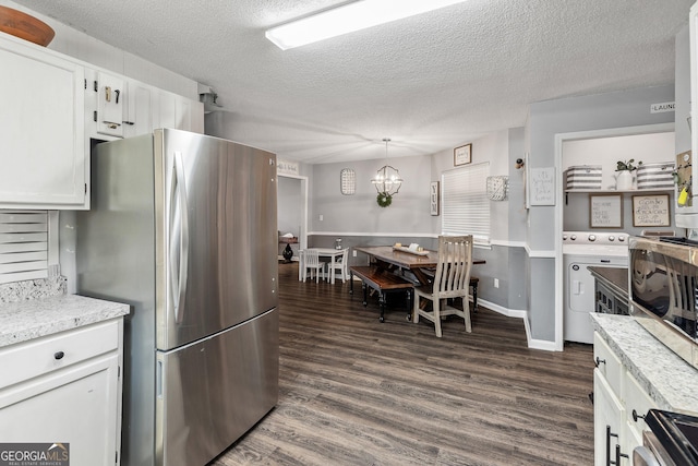 95 Joshua Ct, Zebulon, GA 30295 - kitchen with appliances with stainless steel finishes, a chandelier, dark wood finished floors, a textured ceiling, and white cabinetry