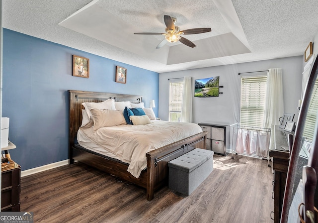 95 Joshua Ct, Zebulon, GA 30295 - bedroom with a textured ceiling, a tray ceiling, wood finished floors, and a ceiling fan