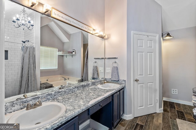 95 Joshua Ct, Zebulon, GA 30295 - full bathroom with a garden tub, double vanity, tiled shower, wood finished floors, and a chandelier