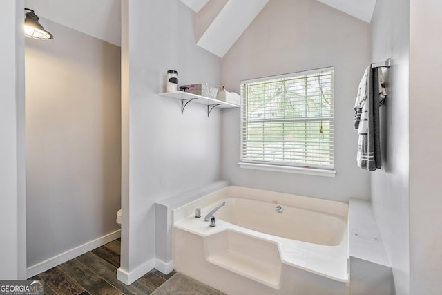 95 Joshua Ct, Zebulon, GA 30295 - bathroom featuring wood finished floors, a garden tub, and lofted ceiling