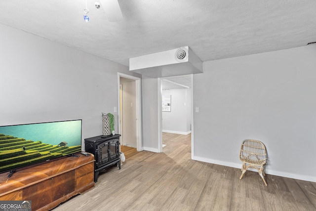 95 Joshua Ct, Zebulon, GA 30295 - sitting room featuring a wood stove and wood finished floors
