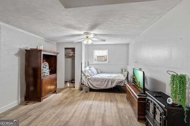 95 Joshua Ct, Zebulon, GA 30295 - bedroom with light wood-type flooring, a textured ceiling, a ceiling fan, and cooling unit