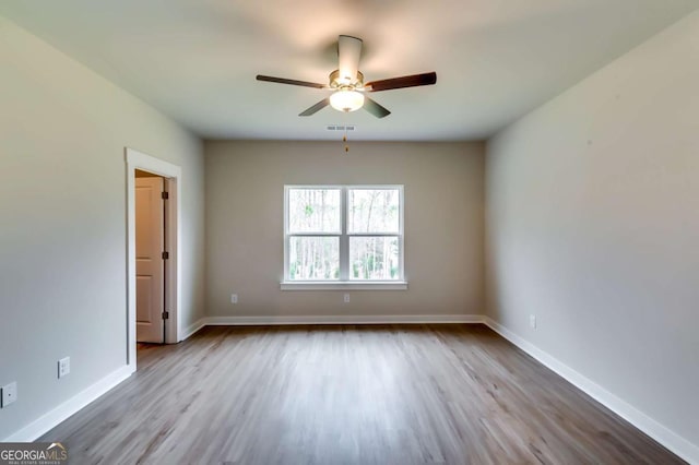497 Principal Meridian Dr, Dallas, GA 30132 - empty room featuring wood finished floors, a ceiling fan, and baseboards