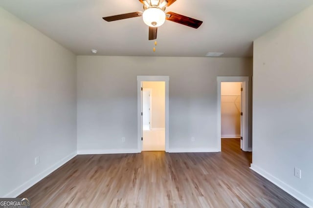 497 Principal Meridian Dr, Dallas, GA 30132 - unfurnished bedroom with a spacious closet, baseboards, wood finished floors, and a closet
