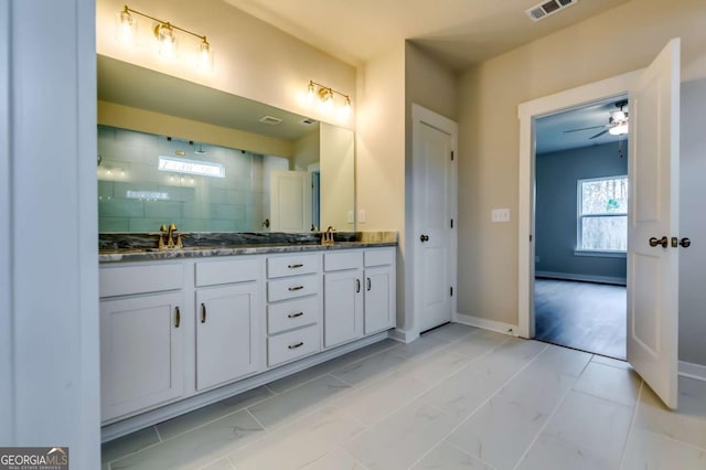 497 Principal Meridian Dr, Dallas, GA 30132 - bathroom featuring double vanity, a tile shower, marble finish flooring, baseboards, and ceiling fan