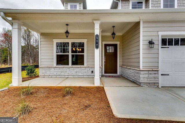 497 Principal Meridian Dr, Dallas, GA 30132 - view of exterior entry with a porch and a garage