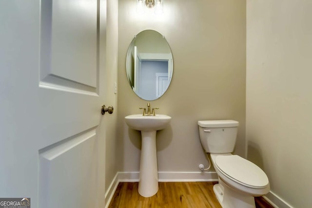 497 Principal Meridian Dr, Dallas, GA 30132 - bathroom with baseboards, toilet, wood finished floors, and a sink