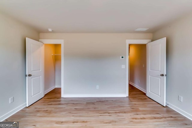 497 Principal Meridian Dr, Dallas, GA 30132 - unfurnished bedroom with light wood-type flooring and baseboards
