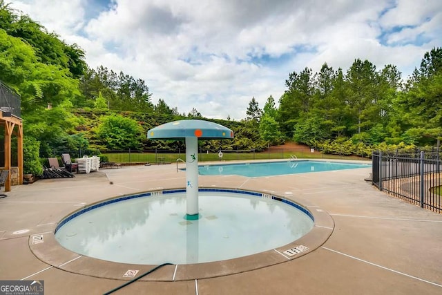 497 Principal Meridian Dr, Dallas, GA 30132 - community pool featuring a patio and view of wooded area