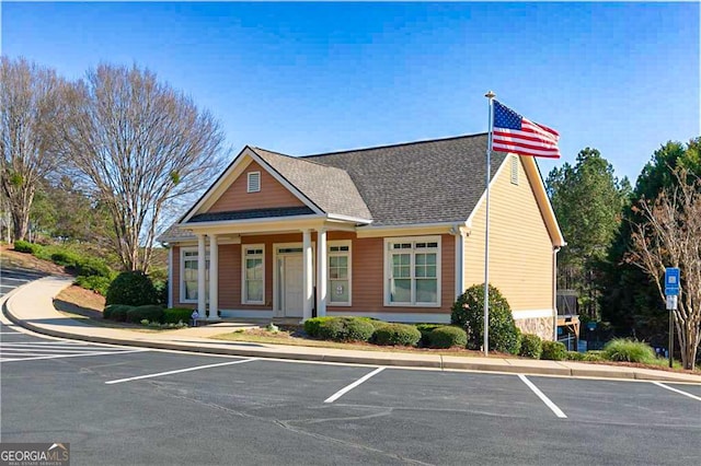 497 Principal Meridian Dr, Dallas, GA 30132 - view of front of home with uncovered parking, a shingled roof, and covered porch