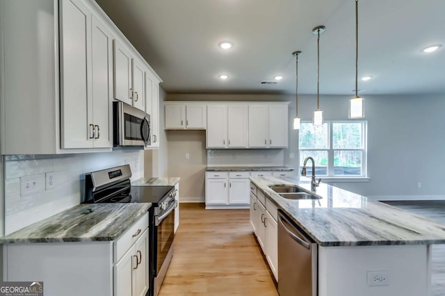 497 Principal Meridian Dr, Dallas, GA 30132 - kitchen featuring stainless steel appliances, a sink, recessed lighting, tasteful backsplash, and white cabinetry