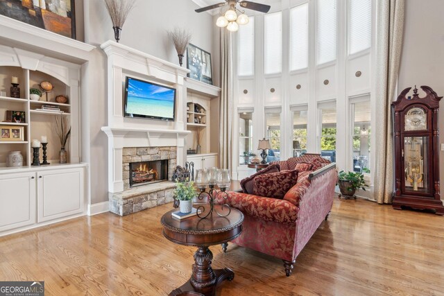 968 Woodtrace Ln, Auburn, GA 30011 - living room with built in features, a high ceiling, and wood finished floors