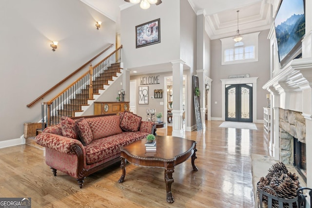 968 Woodtrace Ln, Auburn, GA 30011 - living room with ornamental molding, light wood-type flooring, a high ceiling, and decorative columns