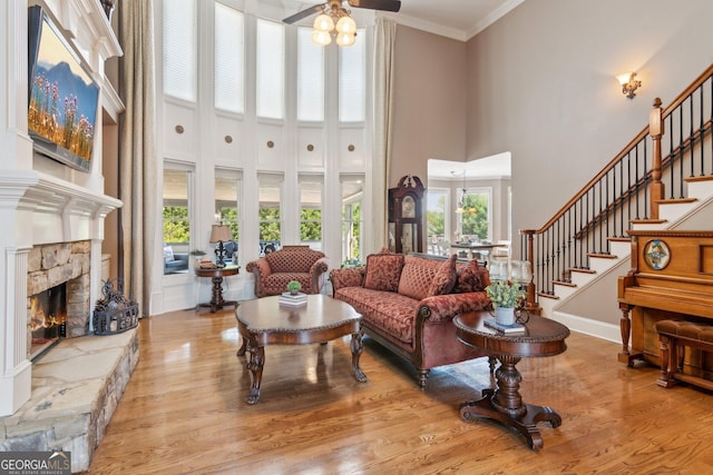 968 Woodtrace Ln, Auburn, GA 30011 - living area with a ceiling fan, a fireplace, a towering ceiling, stairs, and wood finished floors