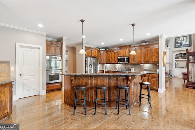 968 Woodtrace Ln, Auburn, GA 30011 - kitchen with crown molding, backsplash, light wood-style flooring, and stainless steel appliances