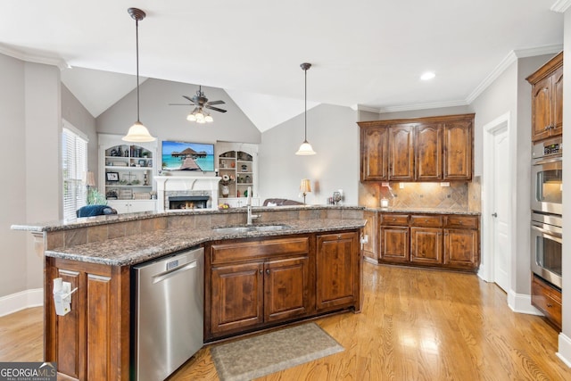 968 Woodtrace Ln, Auburn, GA 30011 - kitchen with light wood-type flooring, a ceiling fan, a warm lit fireplace, a sink, and stainless steel appliances