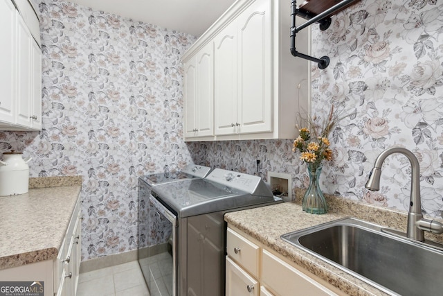 968 Woodtrace Ln, Auburn, GA 30011 - washroom with a sink, wallpapered walls, cabinet space, washer and clothes dryer, and light tile patterned flooring