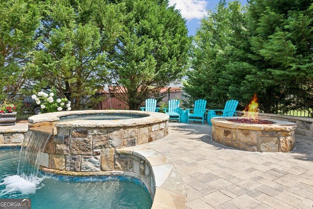 968 Woodtrace Ln, Auburn, GA 30011 - view of pool with an outdoor fire pit, a patio, fence, and an in ground hot tub
