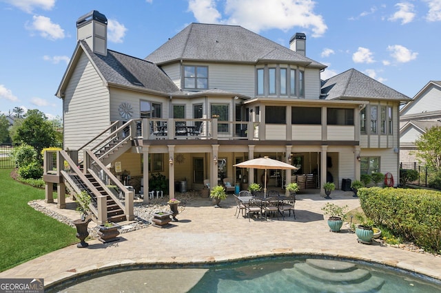 968 Woodtrace Ln, Auburn, GA 30011 - back of house featuring a shingled roof, a chimney, fence, a patio, and stairs