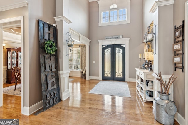 968 Woodtrace Ln, Auburn, GA 30011 - foyer featuring decorative columns, light wood-style flooring, a towering ceiling, french doors, and baseboards