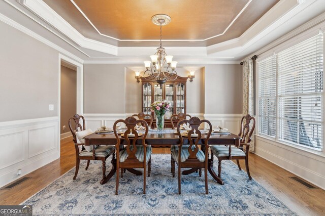 968 Woodtrace Ln, Auburn, GA 30011 - dining space featuring a tray ceiling, a wealth of natural light, a chandelier, and visible vents