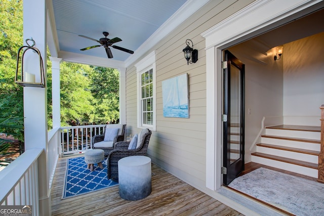 wooden terrace featuring a porch and ceiling fan