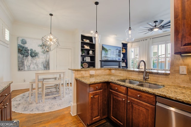 kitchen with a sink, tasteful backsplash, wood finished floors, stainless steel dishwasher, and ornamental molding