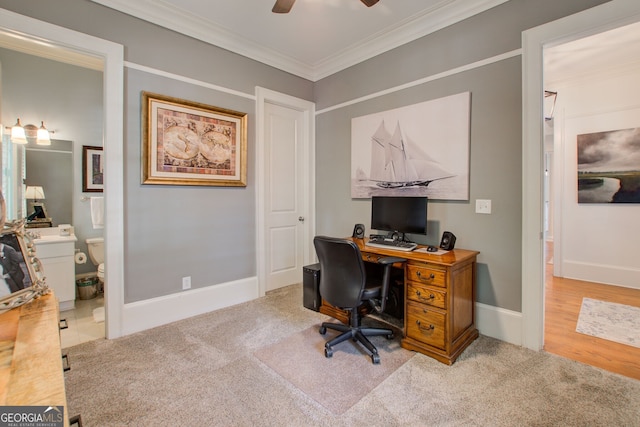home office featuring baseboards, carpet flooring, a ceiling fan, and crown molding