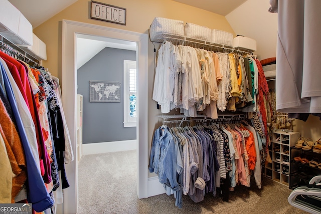 spacious closet featuring carpet flooring and lofted ceiling