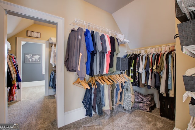 spacious closet with vaulted ceiling and carpet