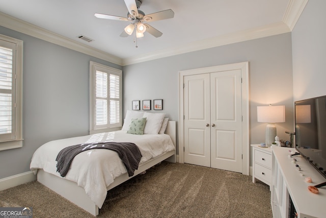bedroom with carpet, visible vents, a closet, and crown molding