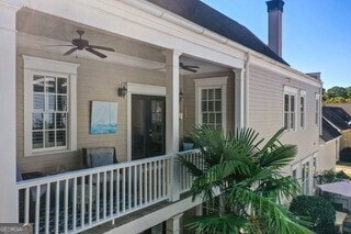 property entrance with a chimney and a ceiling fan