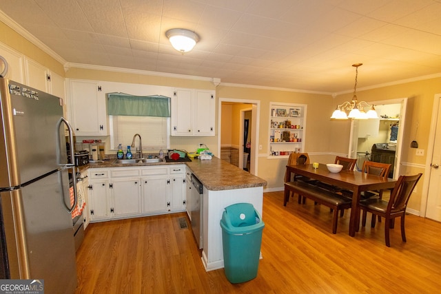 209 Elm St, Brooklet, GA 30415 - kitchen featuring a sink, a chandelier, appliances with stainless steel finishes, dark countertops, and white cabinets