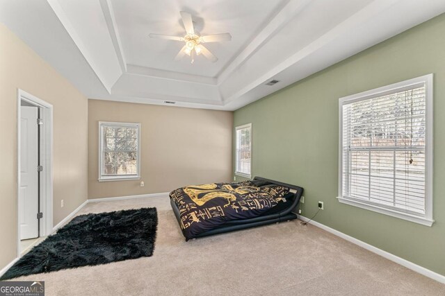 79 Tiffany Trce, Palmetto, GA 30268 - carpeted bedroom featuring a ceiling fan, a tray ceiling, baseboards, and visible vents