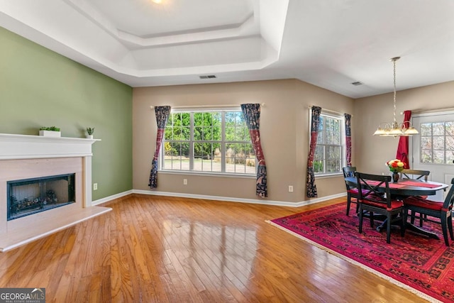 79 Tiffany Trce, Palmetto, GA 30268 - dining area with wood-type flooring, a tray ceiling, baseboards, and visible vents